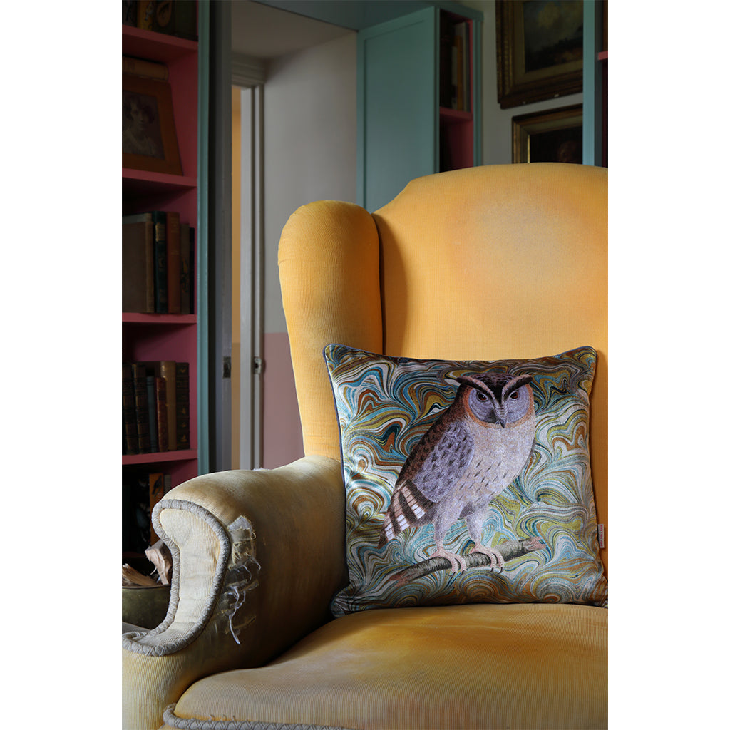 Owl decorative pillow on yellow chair